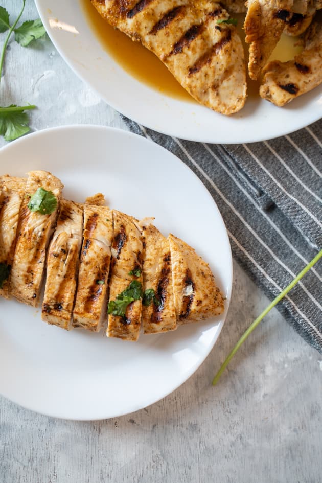 Sliced meal prep grilled chicken on a white plate

